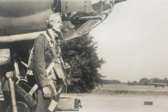 Charles Cooke in Paratrooper Gear in front of Bomber